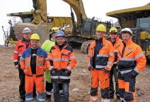 Caterpillar happy bunch in front of two of the G trucks