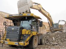 The Cat 775G trucks are loaded by the new Cat 390DL excavator